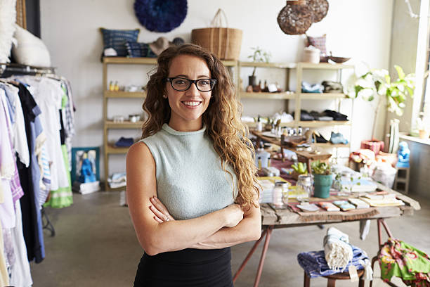 young female business owner in a clothes shop, portrait - butiksarbetare bildbanksfoton och bilder