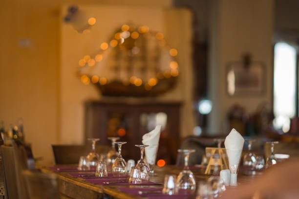 istock Wine glasses on a wooden table in a festive light 638778482