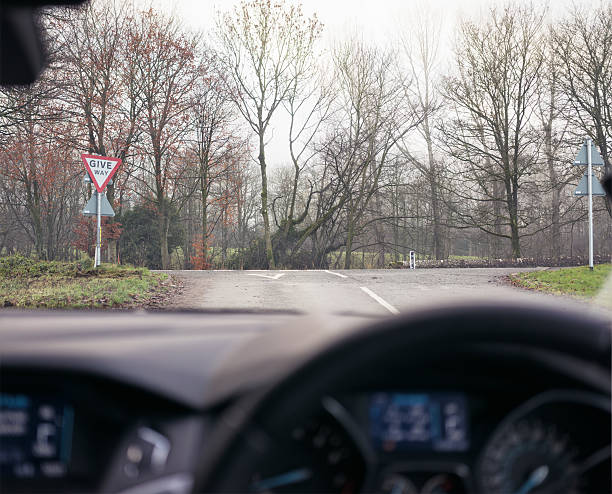 A driver's view, approachign a T Junction on a rural English road in winter.