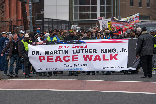 A large and diverse crowd gathers at the Martin Luther King Jr. statue in Denver Colorado's City Park for his annual parade and march or marade, one of the largest Martin Luther King Jr. rallies in the United States.
