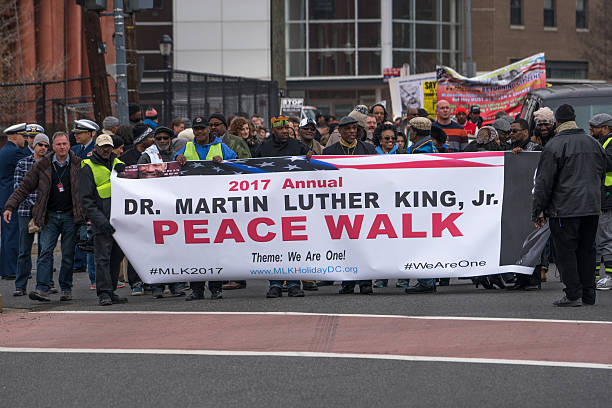 Martin Luther King, Jr. Day Peace Walk and Parade. Washington, DC, - January 16, 2017: Crowds march in the annual Martin Luther King, Jr. Day Peace Walk and Parade. martin luther king jr day stock pictures, royalty-free photos & images