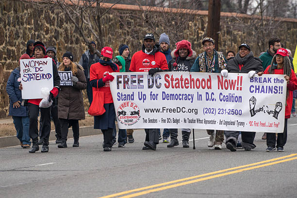DC Statehood Now Washington, DC - January 16, 2017: People march for statehood during the Martin Luther King, Jr. Day Peace Walk abnd Parade. martin luther king jr day stock pictures, royalty-free photos & images