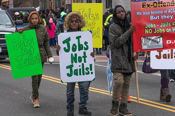 Jobs Not Jails Washington, DC - January 16, 2017: Young people petion for jobs at Martin Luther King, Jr. Day Peace Walk abnd Parade. martin luther king jr day stock pictures, royalty-free photos & images