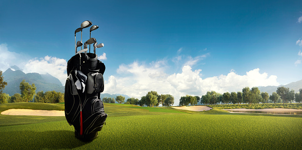 View of the green rolling landscape and bunkers or sand traps at Golf course. The golf field is made in 3D.