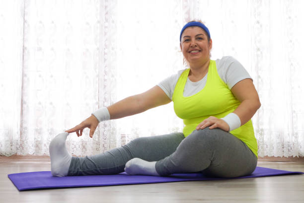 istock Happy woman doing gymnastics at home 638787958