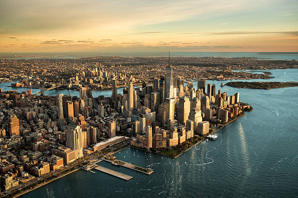 Aerial view of Manhattan island Helicopter point of view of Manhattan island in New York City at sunset. new york city built structure building exterior aerial view stock pictures, royalty-free photos & images