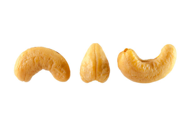 cashew-nüssen haufen auf weißem hintergrund - cashewnuss stock-fotos und bilder