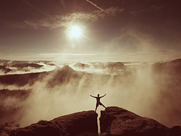 istock Happy man gesture  triumph with arms in air, rock summit 638791540