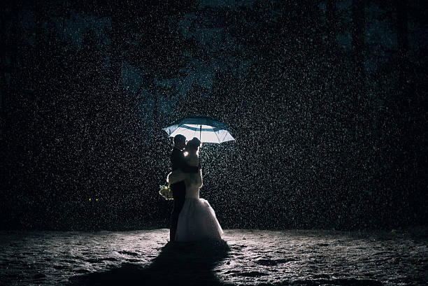istock Wedding couple in the rain and snow 638795104