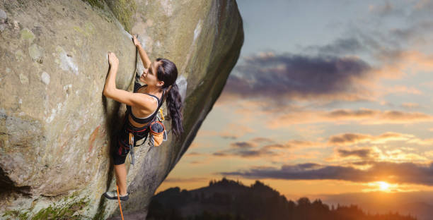 istock Female climber climbing big boulder in nature with rope 638795410