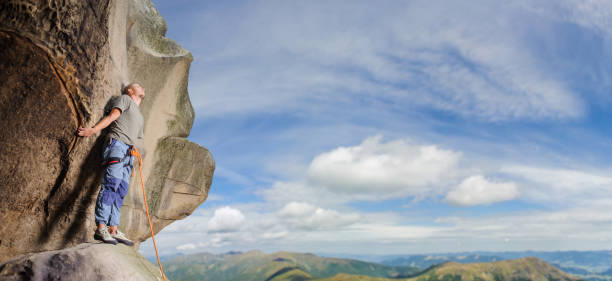 istock Male climber climbing big boulder in nature with rope 638796390