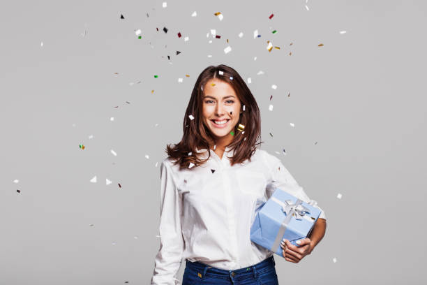 Laughing girl with falling confetti at party