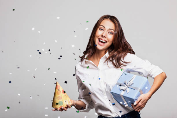istock Laughing girl with falling confetti at party 638797800
