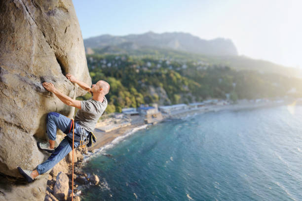 Epic Adventurous Extreme Sport Composite of Rock Climbing Man Rappelling from a Cliff. Perfect for Image Composites. Graphic Resource.