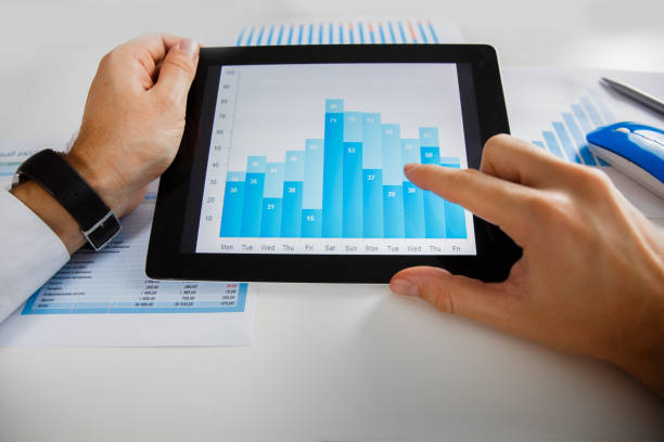 istock Business person analyzing financial statistics displayed on the tablet screen 638798626