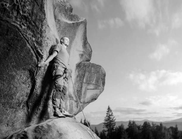 istock Male climber climbing big boulder in nature with rope 638799266