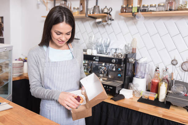 istock Beautiful smiling woman packaging cake. 638799422