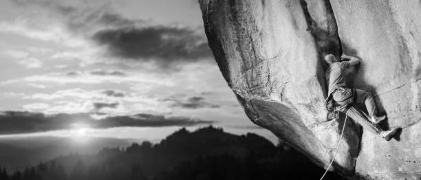 istock Male climber climbing big boulder in nature with rope 638799620
