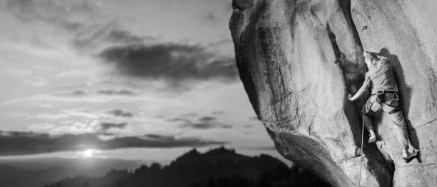 istock Male climber climbing big boulder in nature with rope 638799798