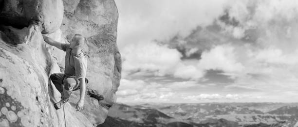 istock Male climber climbing big boulder in nature with rope 638799958