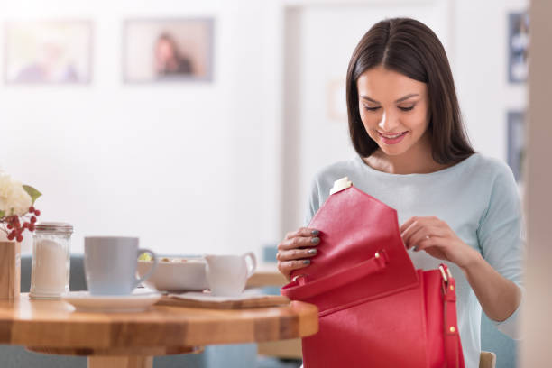 istock Beautiful smiling woman checking her bag in a cafe. 638800156