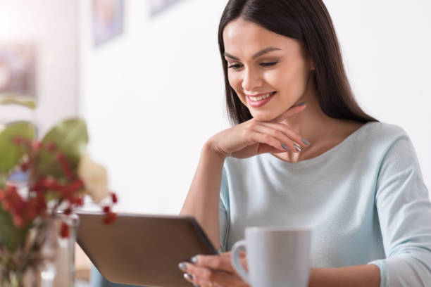 istock Beautiful young brunette woman using a gadget while relaxing. 638800312