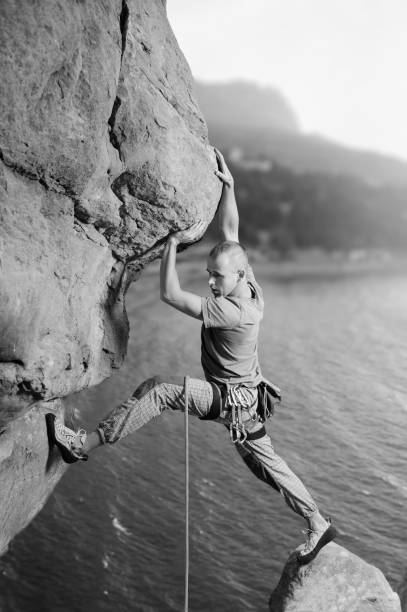 istock Male climber climbing big boulder in nature with rope 638800366