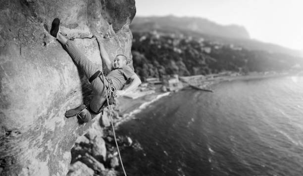 istock Male climber climbing big boulder in nature with rope 638800538