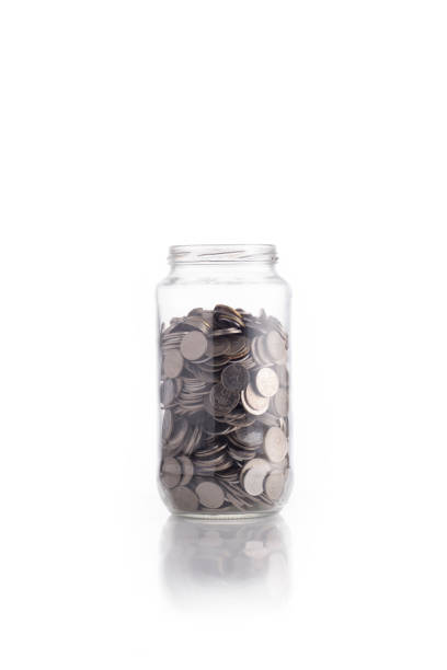 istock Isolated coin in glass jar 638800620