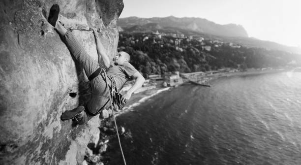 istock Male climber climbing big boulder in nature with rope 638800622