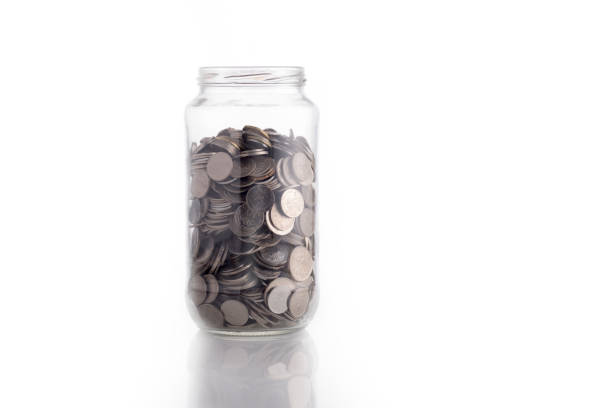 istock Isolated coin in glass jar 638800650
