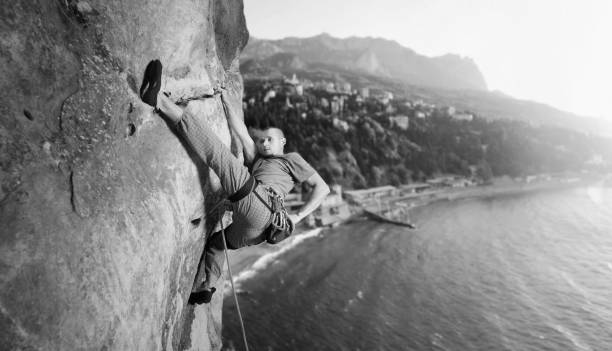 istock Male climber climbing big boulder in nature with rope 638800692