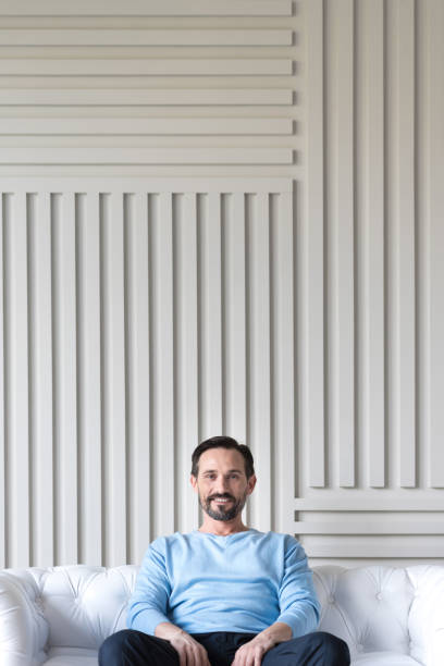 istock Cheerful positive man relaxing on a sofa 638805210