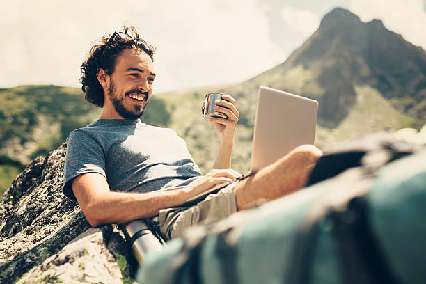 Free Stock Photo of A man sitting on grass with a laptop in front of a ...