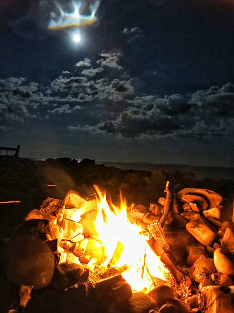 istock Oceanside Homemade Rock Campfire Bonfire Pit, Clouds, Night, Full Moon 638807598