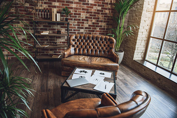 camera arredata in stile loft - armchair sofa leather brown foto e immagini stock