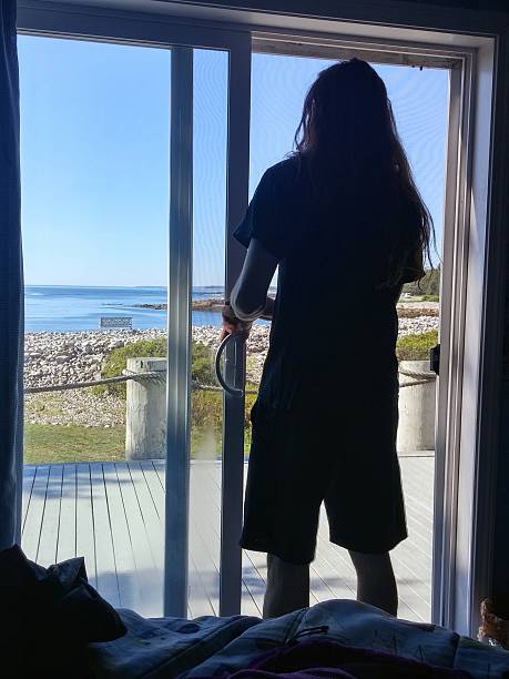 istock Silhouette Long Hair Man Looking Out Window, Maine Shore 638809778