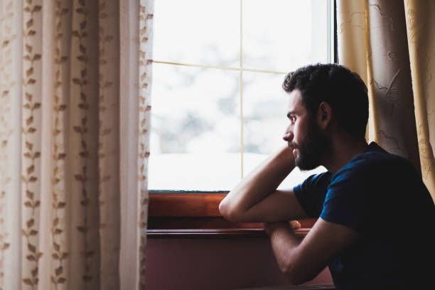 istock Young sad mad sitting by the window 638810874