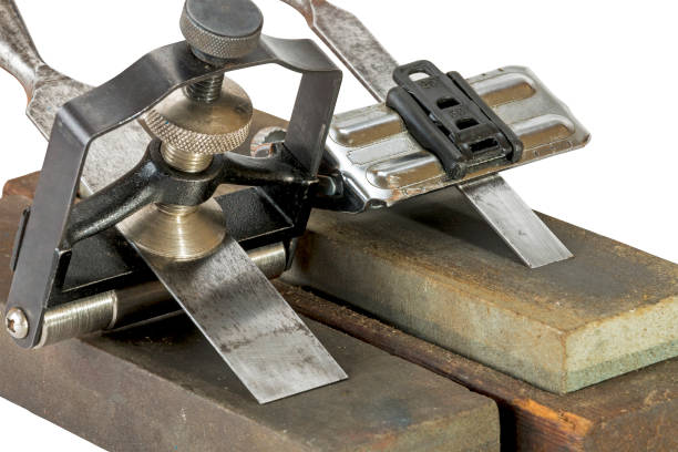 istock Chisels Clamped in Angle Guide Jigs  on Grinding Whetstones 638811048