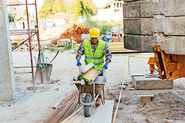 istock Strong manual worker with loaded wheelbarrow 638812202