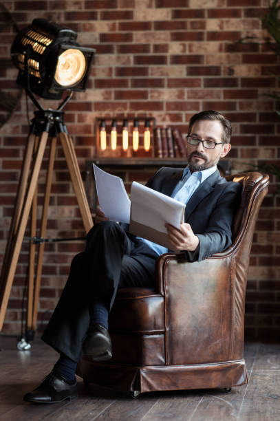 istock Good looking serious businessman reading his notes 638812542