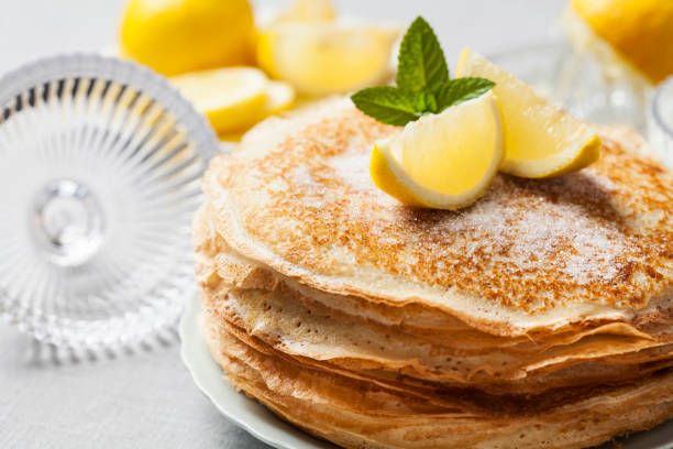 Pancakes English-style pancakes with lemon and sugar, traditional for Shrove Tuesday pancake photos stock pictures, royalty-free photos & images