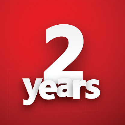 Two years paper sign over red. Vector illustration.