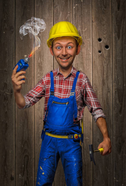 Funny Craftsman with Hammer, cordless screwdriver and helmet