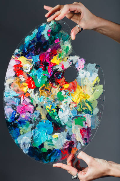 istock The artist's palette stained with paint. On a gray 638817572