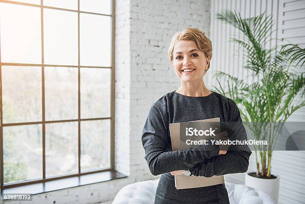 Sincerely Smiling Woman Holding Tablet Stock Photo - Download Image Now - Digital Tablet, Women, One Woman Only