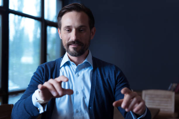 istock Cheerful concentrated man typing on a virtual keyboard 638822814