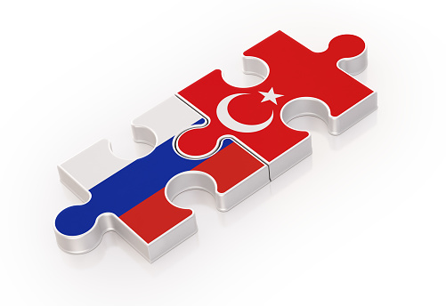 Two puzzles made with Russian and Turkish Flags. Tewamwork Concept. Horizontal composition with copy space. Isolated on white background. Clipping path is included.