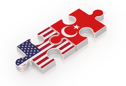 Two puzzles made with USA and Turkish Flags. Tewamwork Concept. Horizontal composition with copy space. Isolated on white background. Clipping path is included.