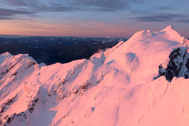 pink glowing sunset lighting mountain peaks cascade mountains - cascade range mountain alpenglow winter - fotografias e filmes do acervo